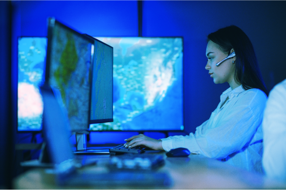 Image of a person working on a computer with code on the screen